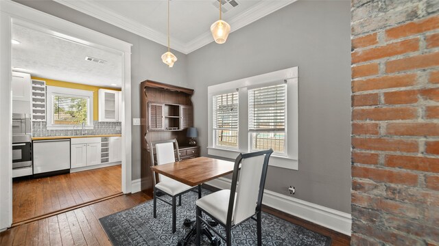 dining room featuring wine cooler, ornamental molding, sink, and dark wood-type flooring