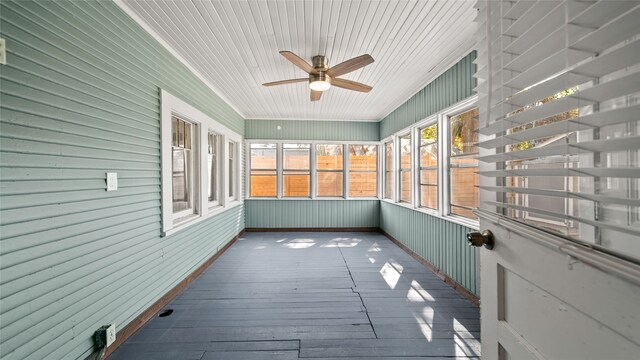 unfurnished sunroom featuring ceiling fan