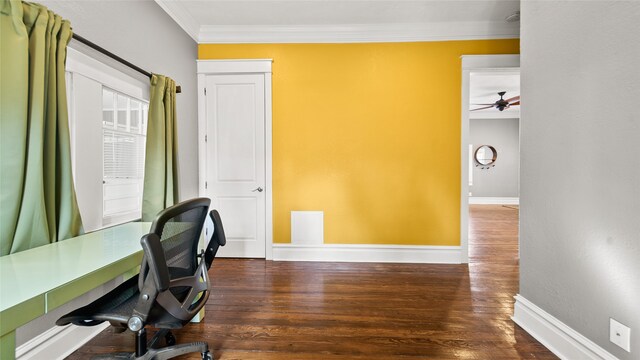 home office with dark wood-type flooring, crown molding, and ceiling fan