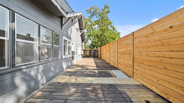 view of side of property with cooling unit and a deck