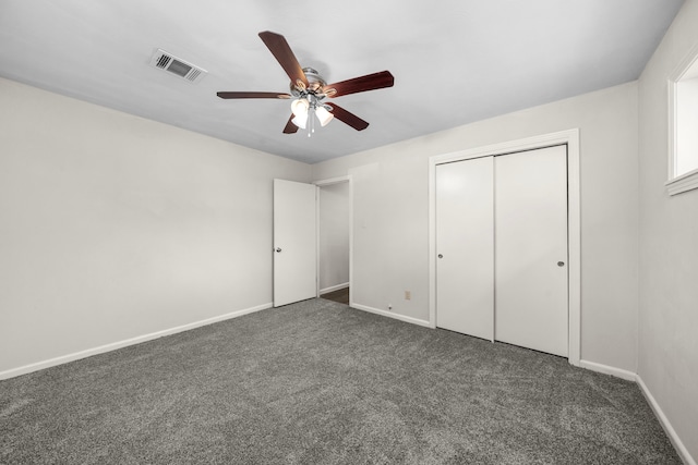 unfurnished bedroom featuring a closet, dark carpet, and ceiling fan