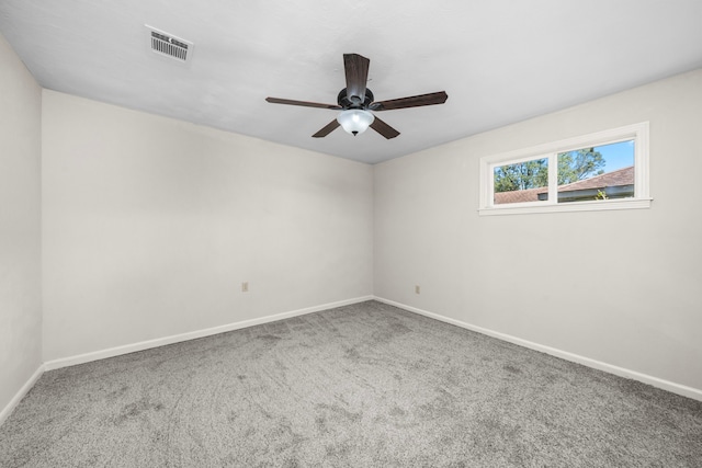 spare room featuring carpet flooring and ceiling fan