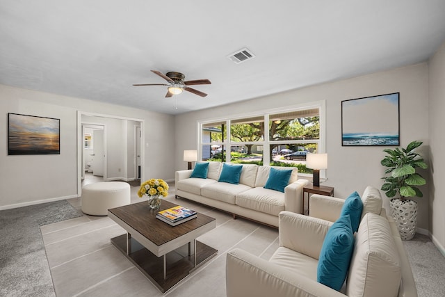 carpeted living room with ceiling fan