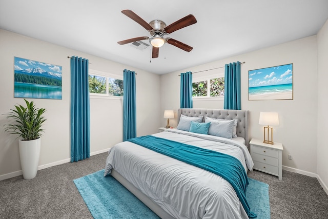 carpeted bedroom featuring multiple windows and ceiling fan