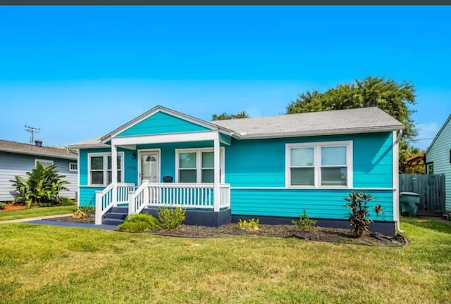 bungalow featuring a porch and a front lawn