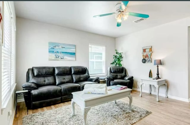 living room with ceiling fan and light wood-type flooring