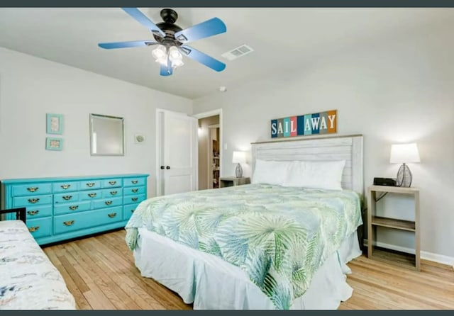 bedroom with ceiling fan and light hardwood / wood-style floors