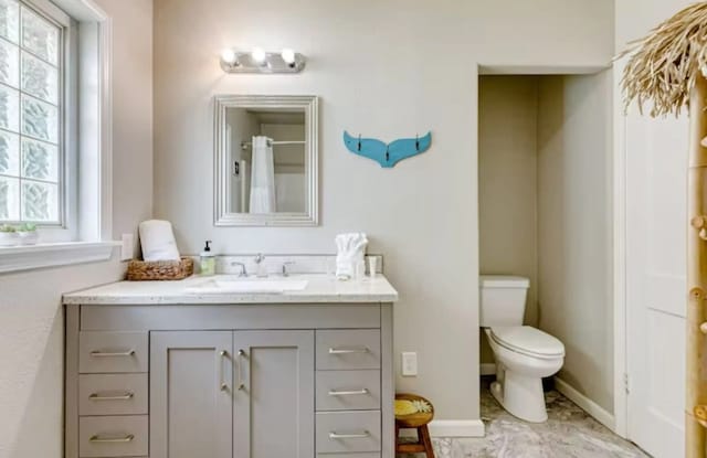 bathroom featuring vanity and toilet