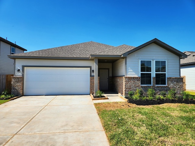 view of front of house featuring a front yard and a garage