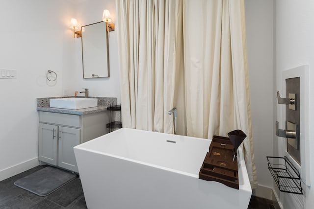 bathroom with a bathtub, tile patterned floors, and vanity