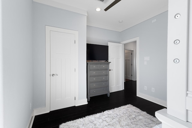 bedroom with dark hardwood / wood-style flooring