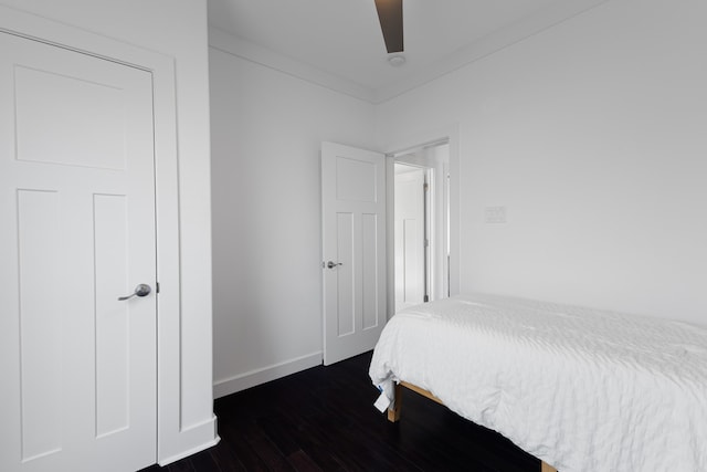 bedroom with ceiling fan and dark hardwood / wood-style flooring