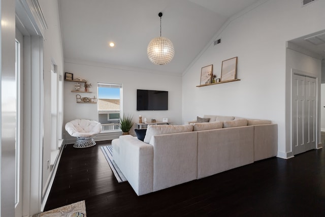 living room featuring ornamental molding, a notable chandelier, lofted ceiling, and dark wood-type flooring