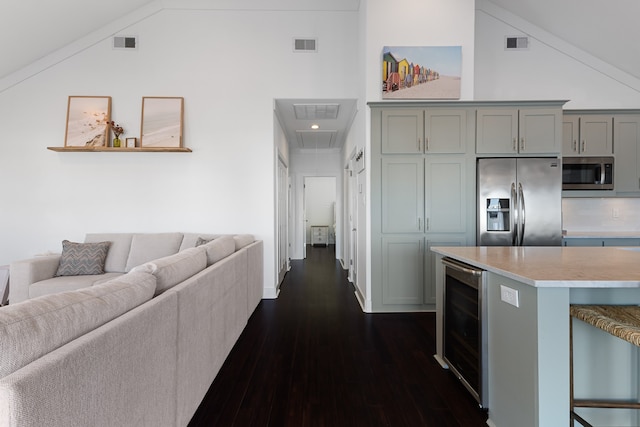 kitchen featuring gray cabinets, wine cooler, dark hardwood / wood-style floors, high vaulted ceiling, and appliances with stainless steel finishes