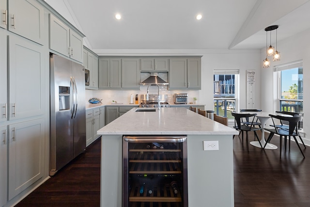 kitchen with an island with sink, beverage cooler, stainless steel refrigerator with ice dispenser, and range hood