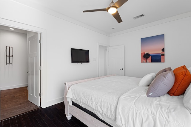 bedroom with ceiling fan and dark hardwood / wood-style flooring