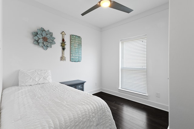 bedroom featuring crown molding, ceiling fan, and dark wood-type flooring