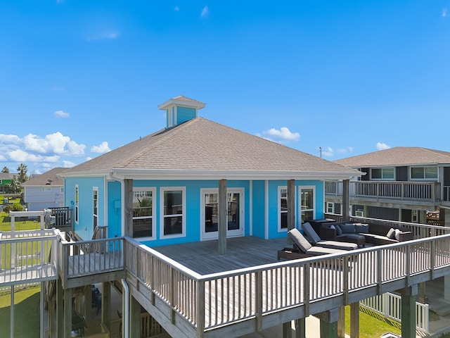 rear view of property featuring outdoor lounge area and a deck