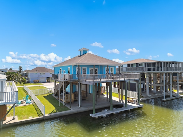 dock area featuring a lawn, a patio area, and a deck with water view