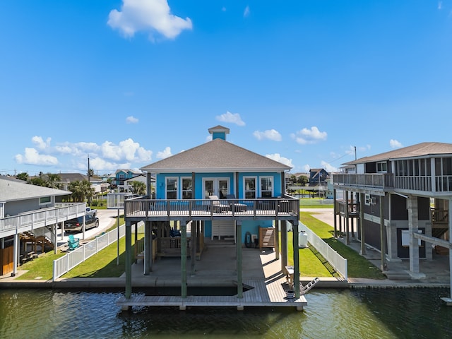 view of dock featuring a yard, a patio area, and a deck with water view