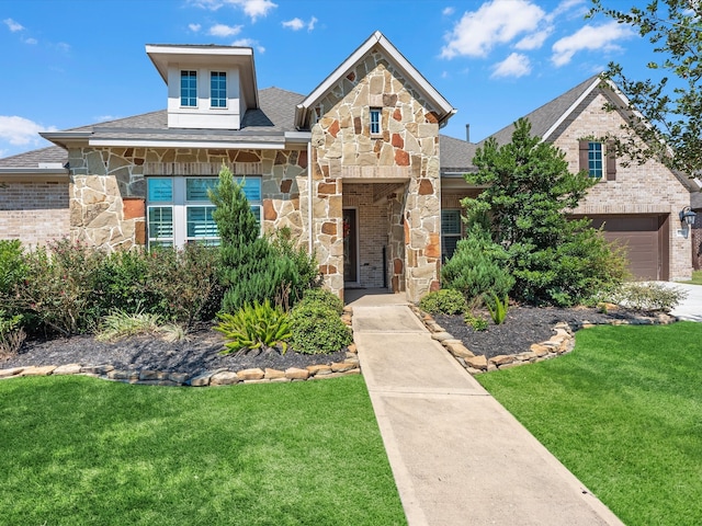 view of front of property featuring a front lawn and a garage