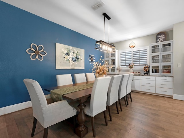 dining area with hardwood / wood-style floors