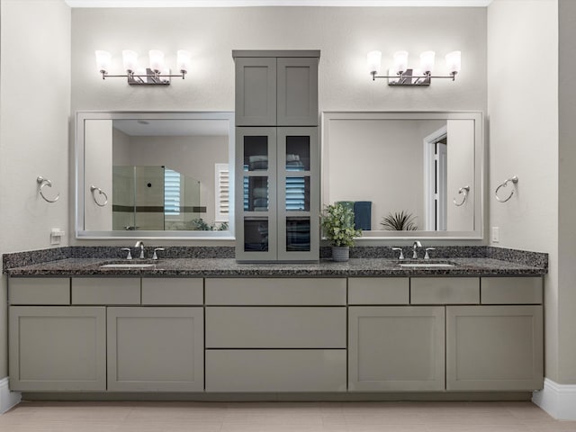 bathroom with tile patterned floors, vanity, and a shower with door