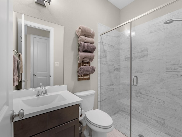 bathroom with vanity, toilet, and an enclosed shower