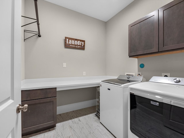 clothes washing area featuring separate washer and dryer and cabinets