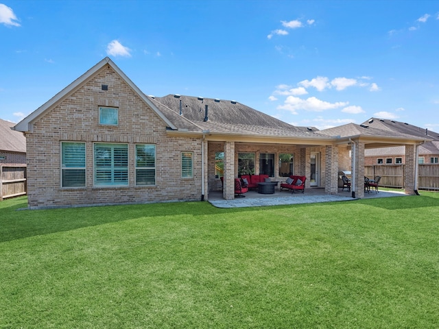 rear view of property with a lawn, outdoor lounge area, and a patio