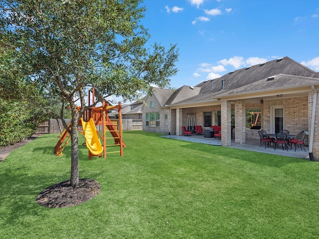 view of yard with a playground and a patio area