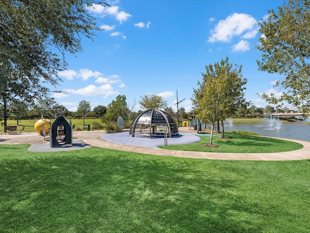 view of playground featuring a yard and a water view