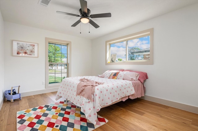 bedroom with ceiling fan and light hardwood / wood-style floors