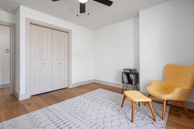 living area featuring ceiling fan and wood-type flooring