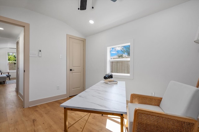 home office with vaulted ceiling and light hardwood / wood-style flooring