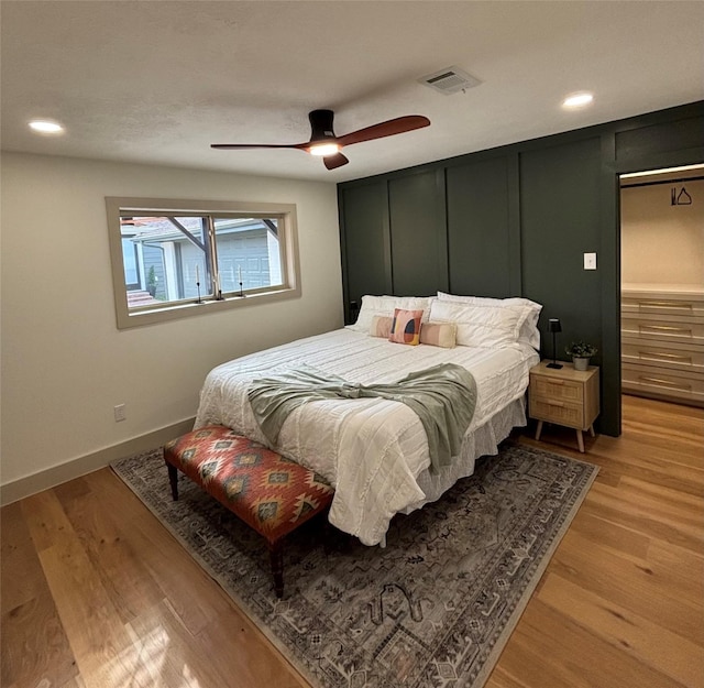 bedroom with light hardwood / wood-style flooring and ceiling fan