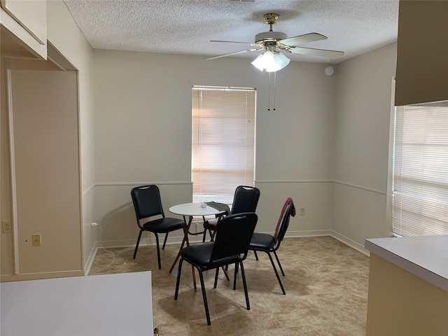 dining area featuring a textured ceiling and ceiling fan