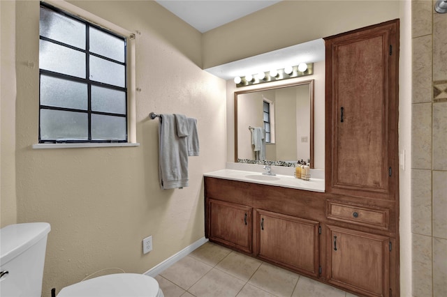 bathroom featuring tile patterned flooring, vanity, and toilet