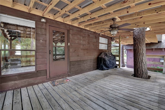 wooden terrace with grilling area and ceiling fan