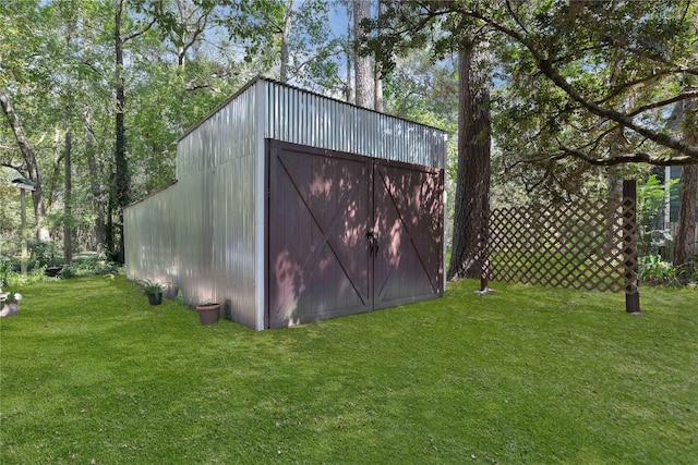 view of outbuilding featuring a yard