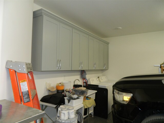 washroom with cabinets and separate washer and dryer