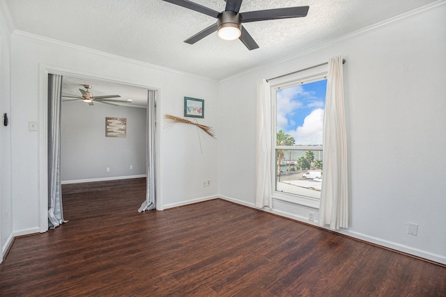 spare room with a textured ceiling, crown molding, baseboards, and wood finished floors