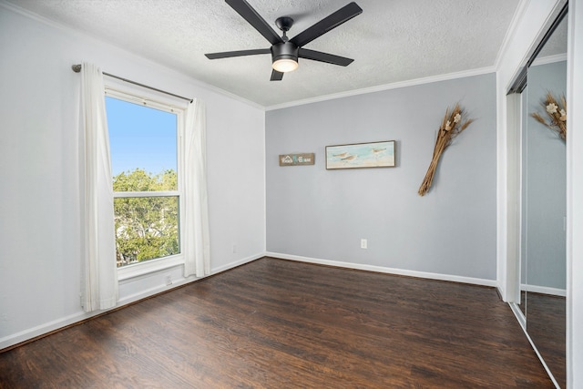 unfurnished room with crown molding, dark wood-type flooring, ceiling fan, and a textured ceiling