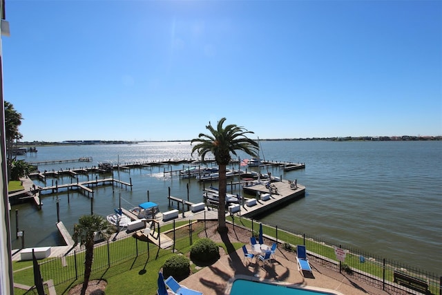 view of dock with a water view and a lawn