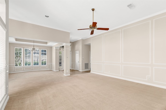 unfurnished living room with ornate columns, light carpet, crown molding, and ceiling fan with notable chandelier