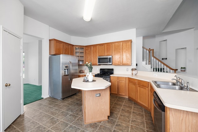 kitchen with stainless steel appliances, kitchen peninsula, a kitchen island, and sink