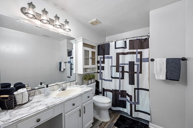 bathroom featuring vanity, toilet, and wood-type flooring