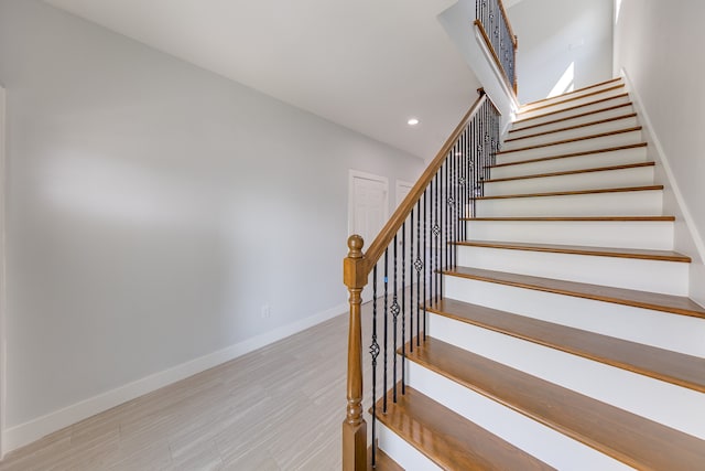 stairway featuring hardwood / wood-style flooring