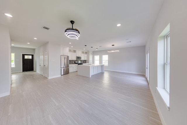 unfurnished living room with plenty of natural light