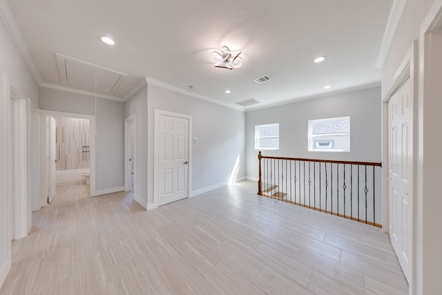 spare room with crown molding and light hardwood / wood-style flooring